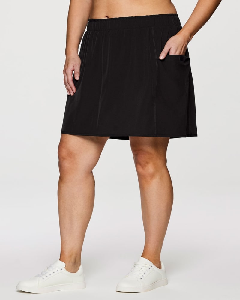 Front of a model wearing a size 1X Plus On Course 19" Skort in Black by RBX Active. | dia_product_style_image_id:352937